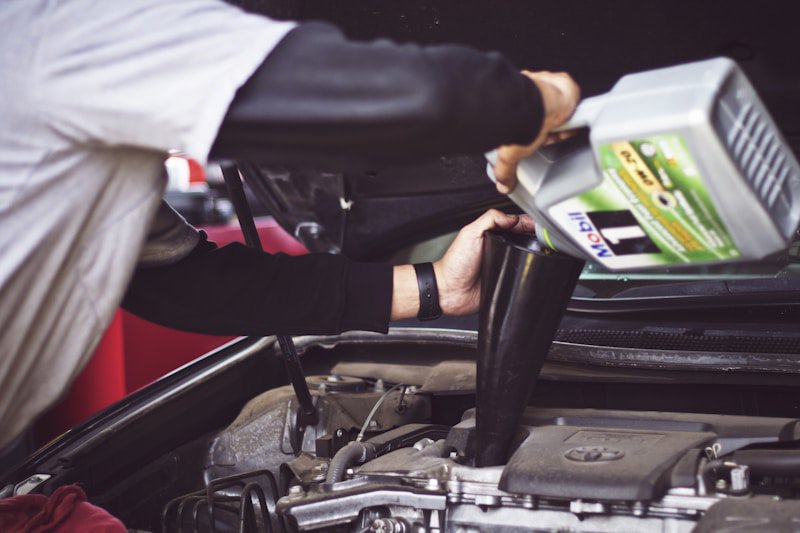 Regular fluid checks are the backbone of car longevity Person checking car engine oil