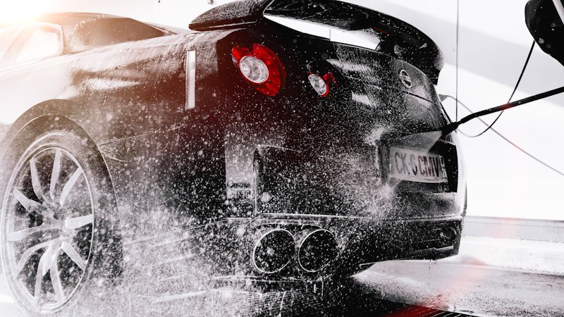 Regular washing protects paint and prevents rust Person washing a car with foam