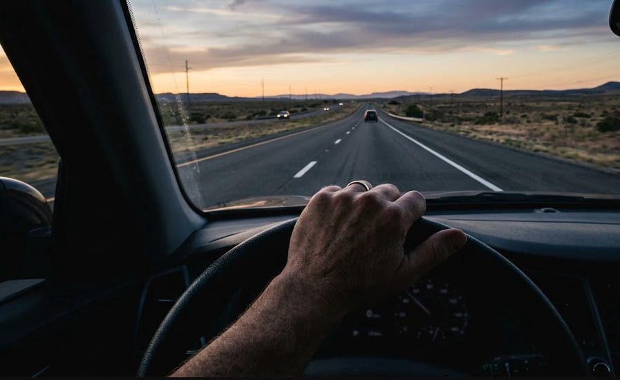 View through windshield driving a hybrid pickup on open highway